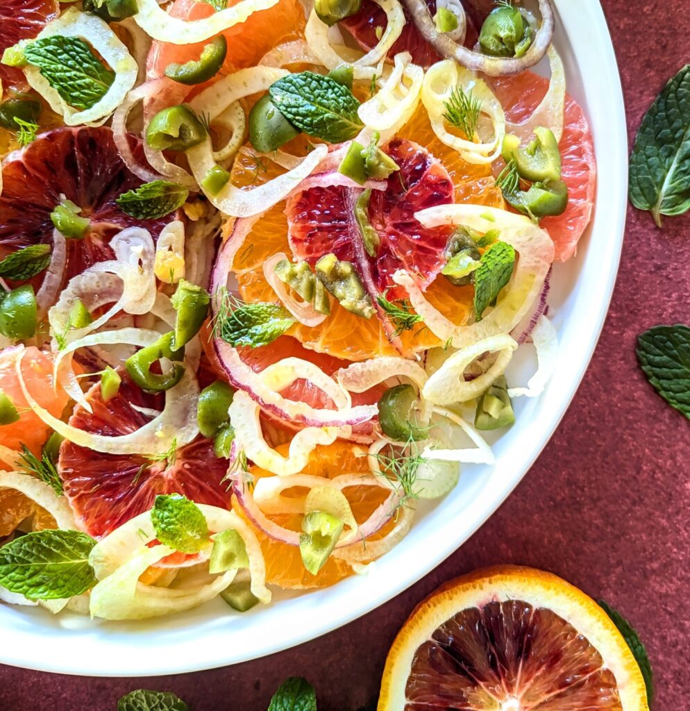 Closeup of a vibrant winter citrus salad with blood oranges, sumo, grapefruit, and mandarin.