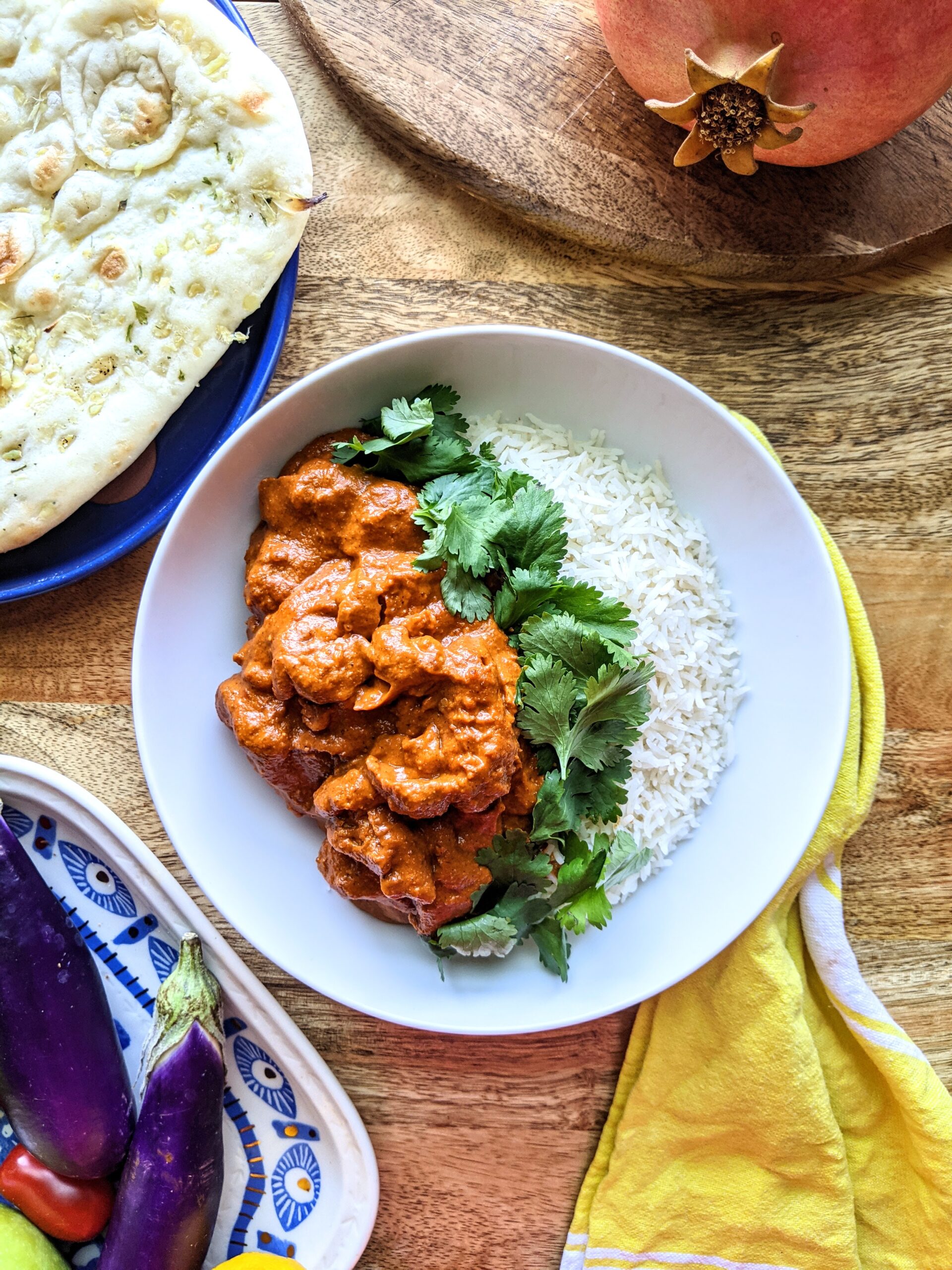 A bowl of rich tomato based butter chicken. Serve over basmati rice and alongside warm naan bread. Garnished with a generous amount of fresh cilantro.