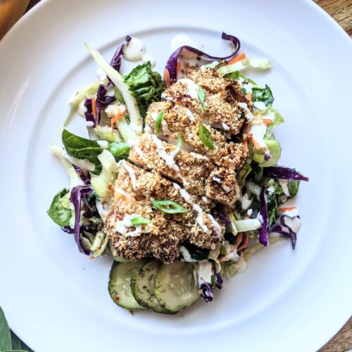 Crispy baked ranch chicken breast served atop crunchy broccoli, purple cabbage, and kale slaw. Garnished with homemade cucumber pickles.