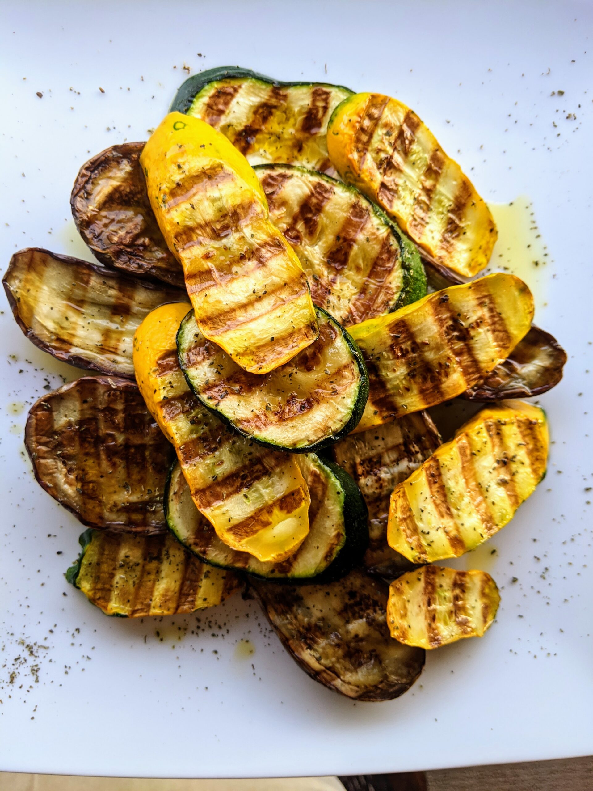 A pile of grilled yellow & green zucchini and eggplant.