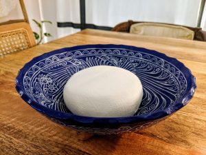 a finished puck of labneh sitting in a bowl.