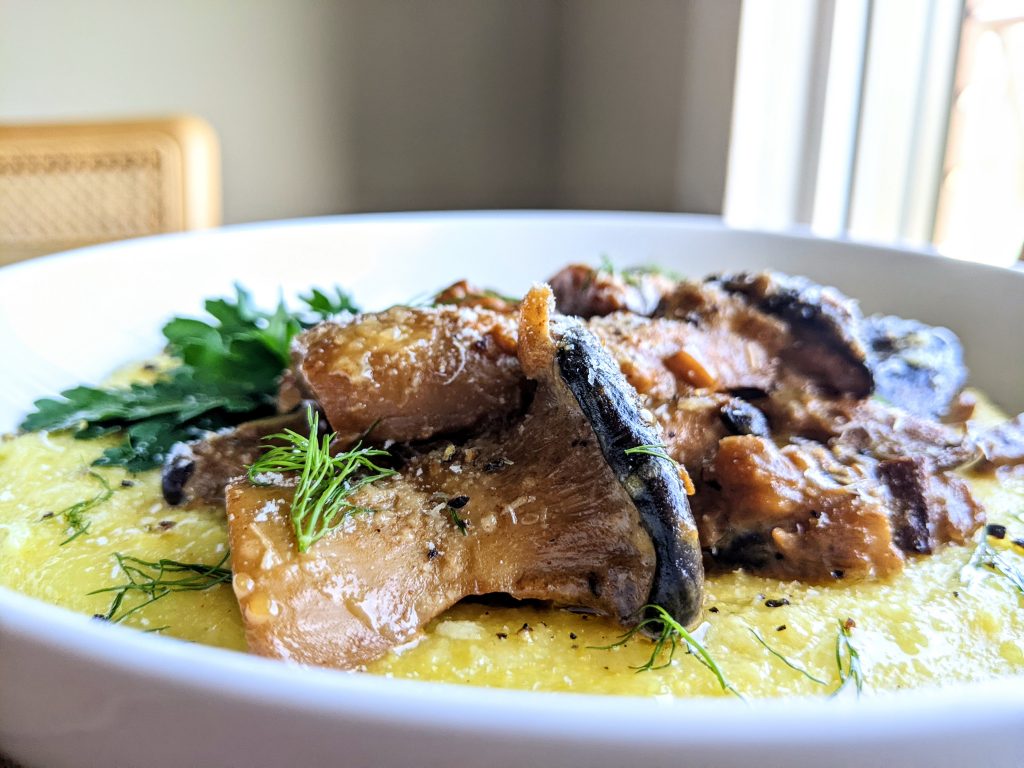 Close-up of mushrom ragu on creamy polenta.