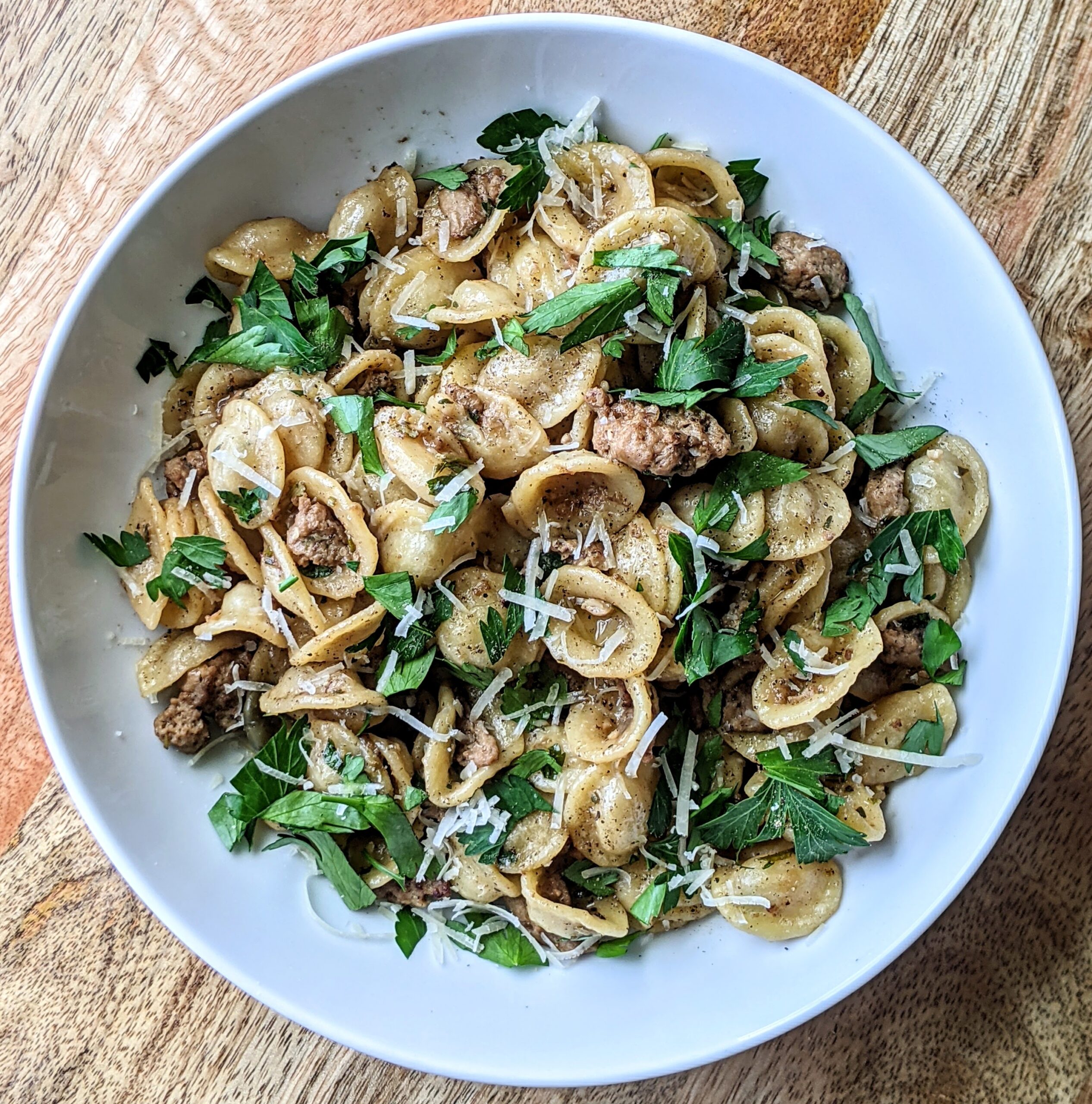 A bowl of orecchiette tossed in a hearty turkey ragu. The fresh rosemary and thyme lend a holiday like flavor to this pasta dish. Topped with fresh parsley and finely grated Parmigiano Reggiano cheese.
