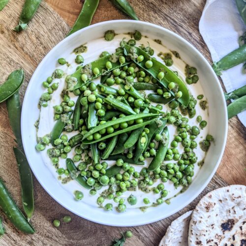 A duo of garden and English peas, tossed in a fresh herb and shallot vinaigrette, served atop a pillow of lime infused whipped labneh. Served alongside warm pita bread.