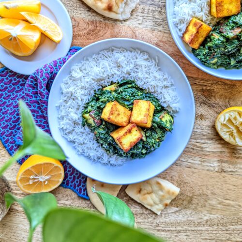 Pan-fried paneer cheese with spinach gravy over basmati rice