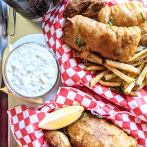 Creamy, tangy, and slightly spicy Tartar Sauce next to baskets of fish and chips.