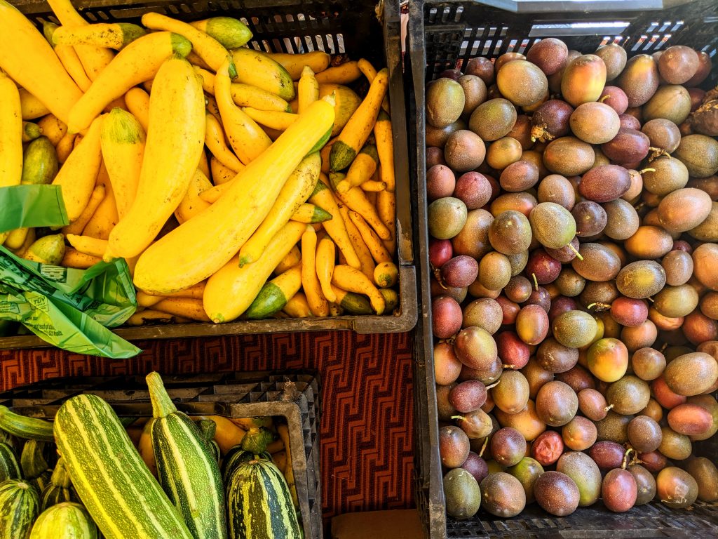 Baskets of summer squash and passion fruits at the Ferry Building Farmers Market in San Francisco.