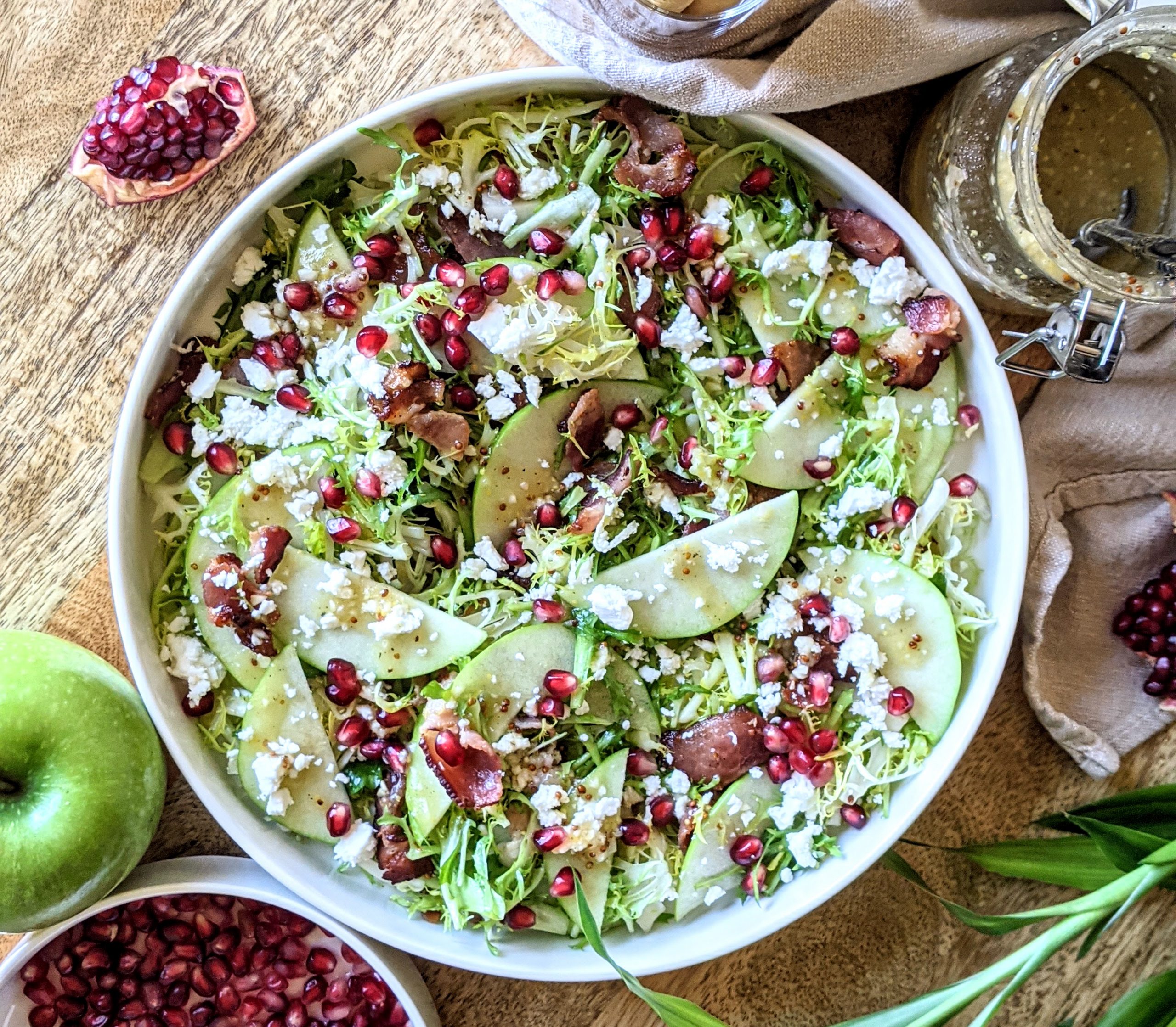 Fall frisée salad with pomegranate, apple, bacon, and feta.