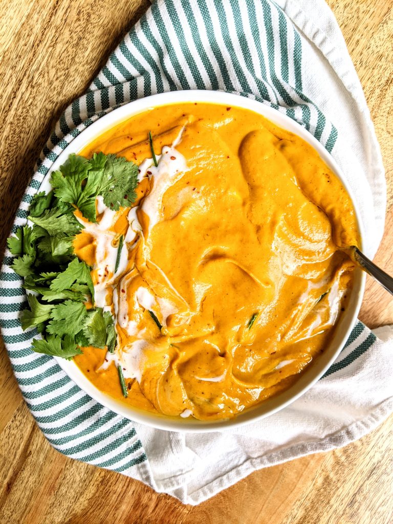 A close up of a bowl of Carrot Coconut Curry Soup.