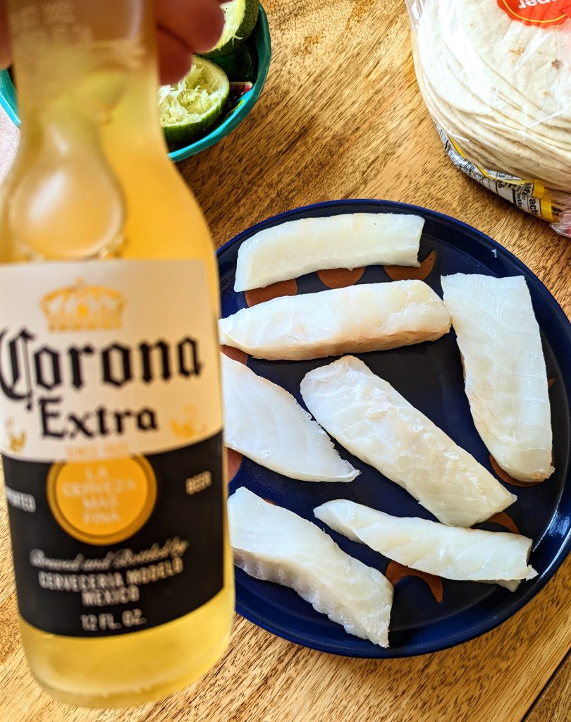 Corona Beer and raw pieces of cod