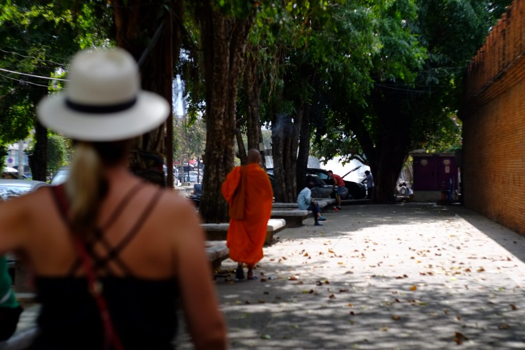 Walking behind a monk in his orange robe down the streets of Chiang Mai Thailand.