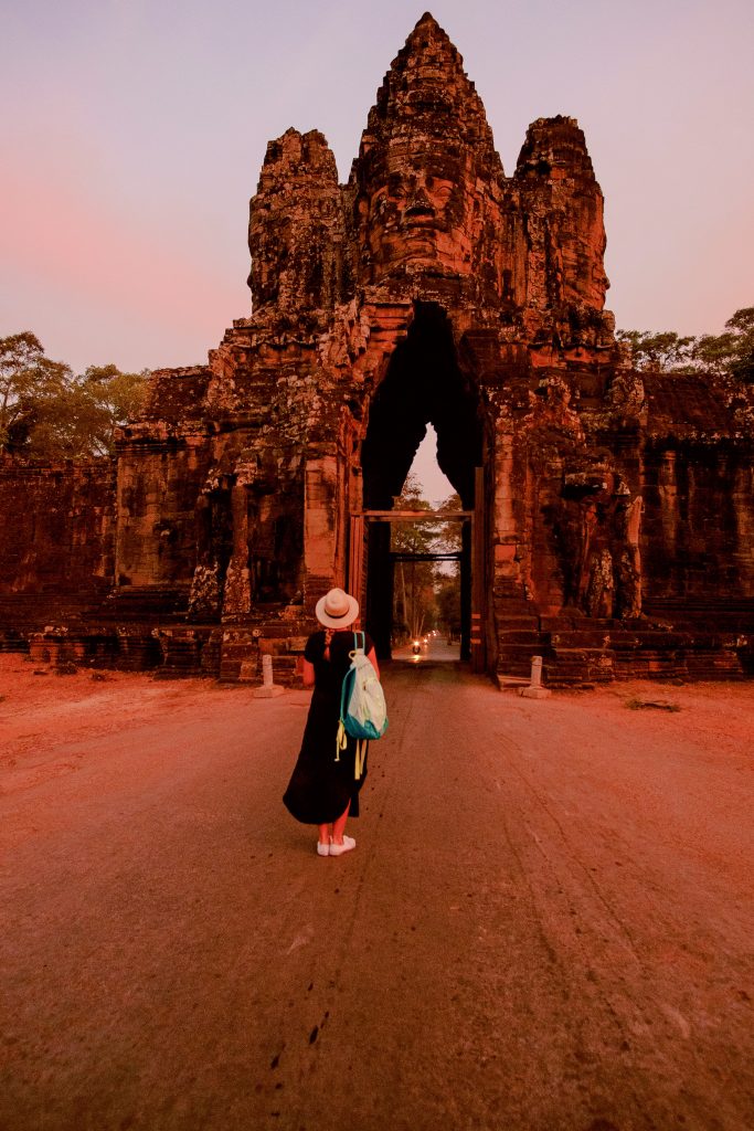 Standing in the middle of the road of the South Gate entrance to Ta Phrom at sunrise.