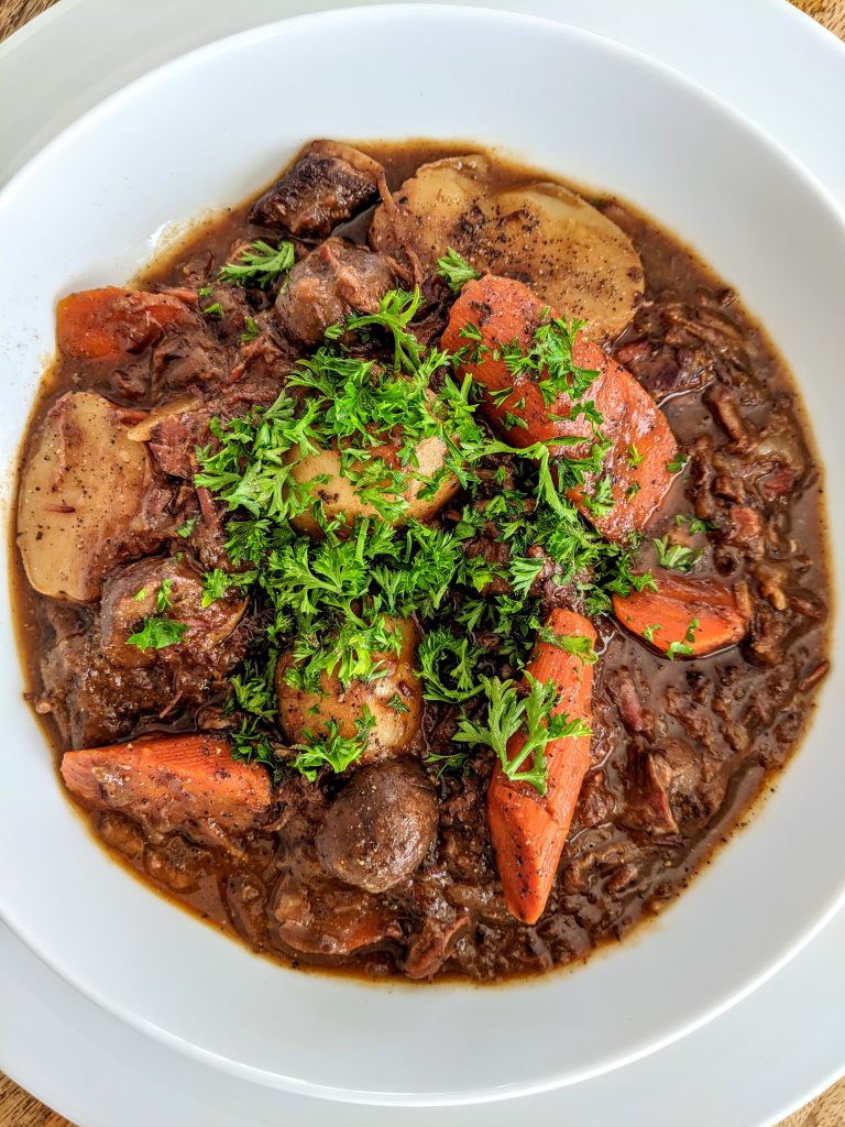 A bowl of rich French-Style Beef Stew with thick cut carrots.