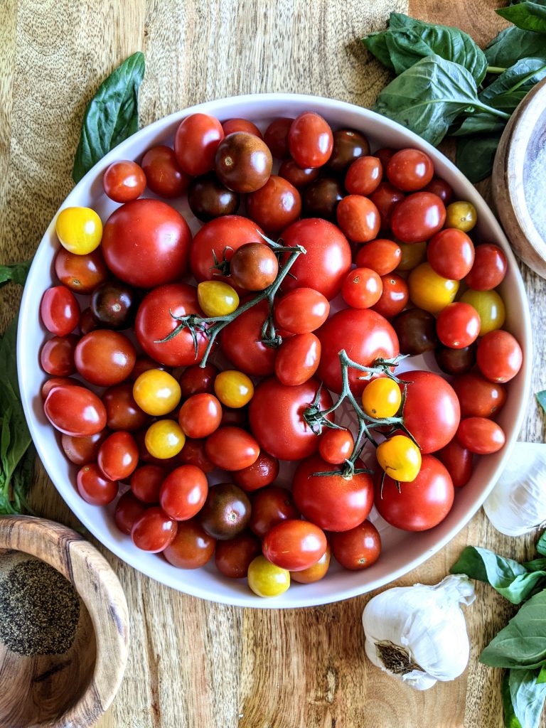 A large plate of assorted multi-colored tomatoes.