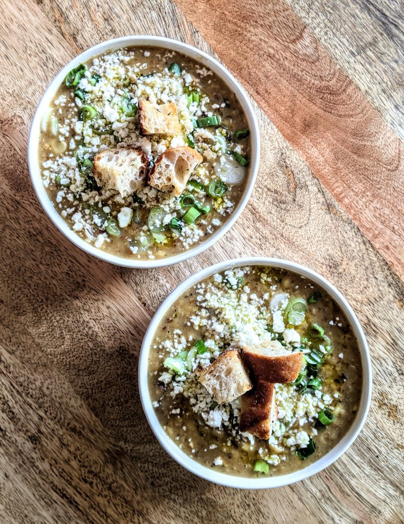 Twin bowls of leftover Roasted Poblano and Corn Chowder, garnished with lots of crumbled cotija cheese and homemade croutons.