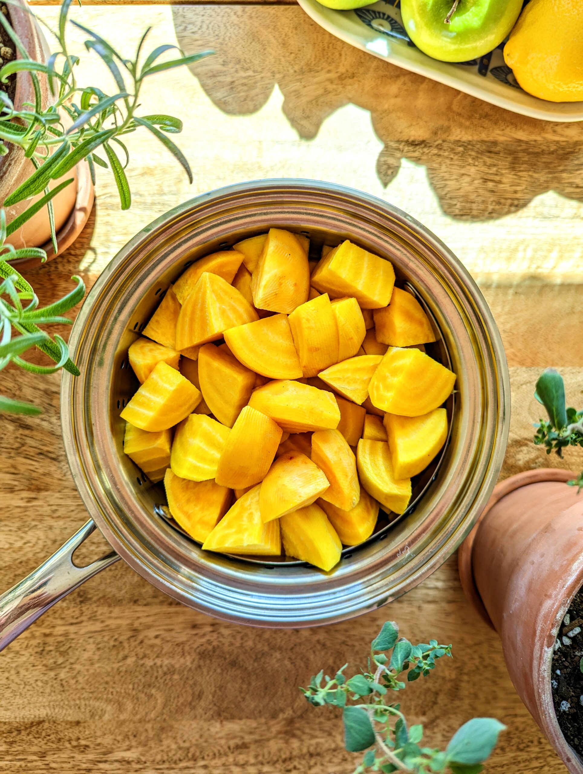 A pot of chopped golden beets ready to be steamed.