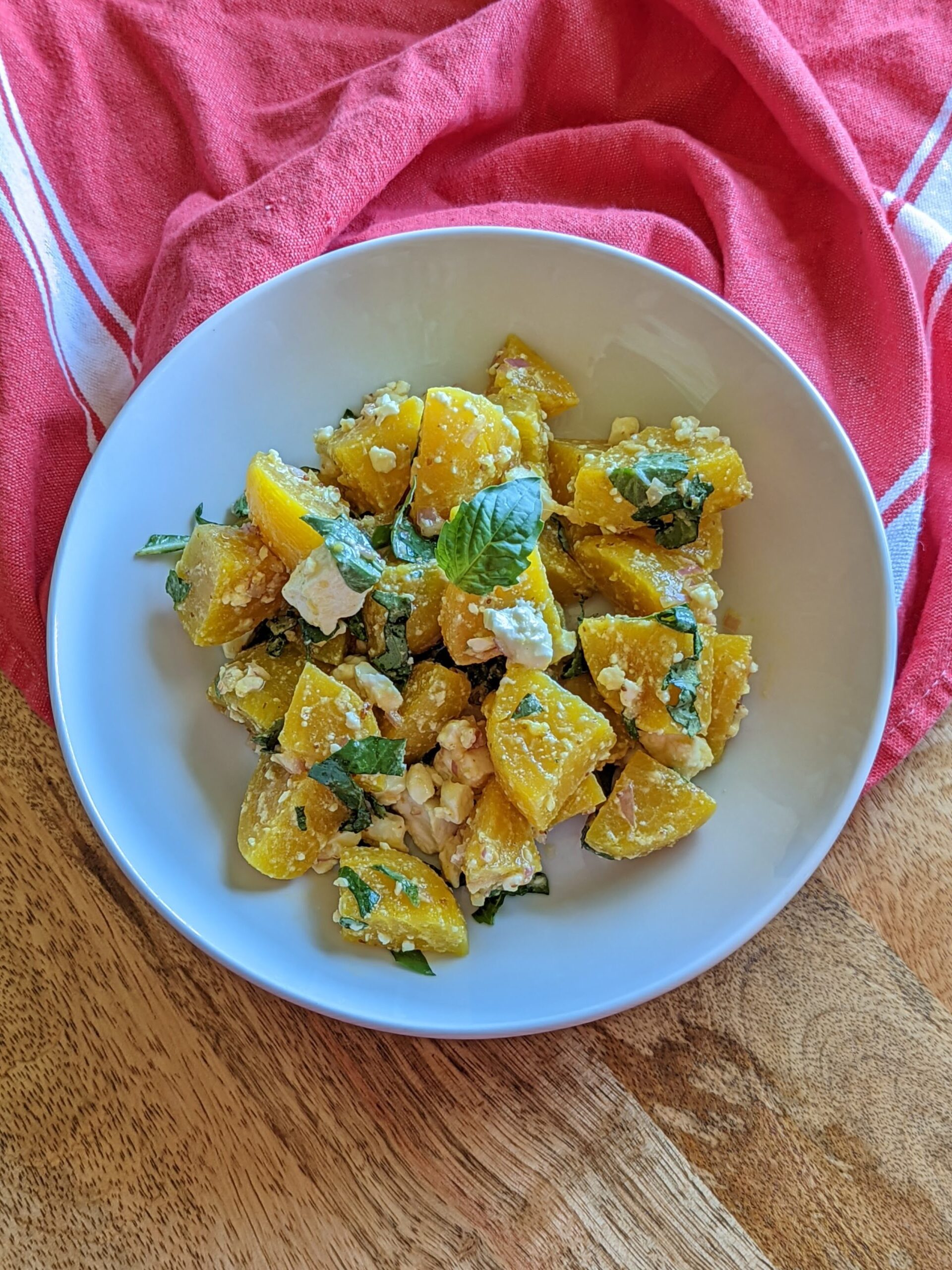 An aerial shot of golden beet salad with feta and basil.