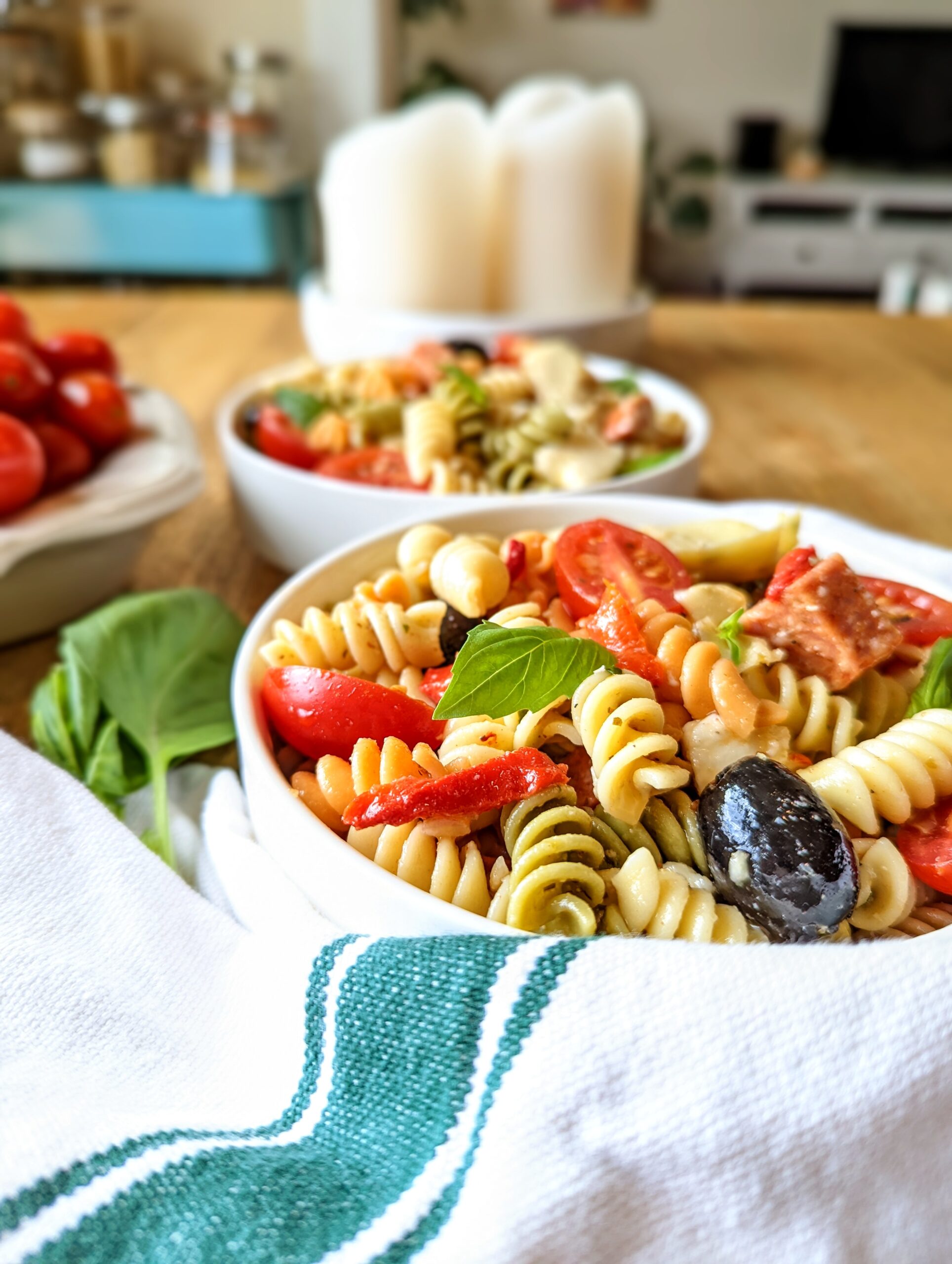 A table level shot of a bowl of antipasto pasta salad.