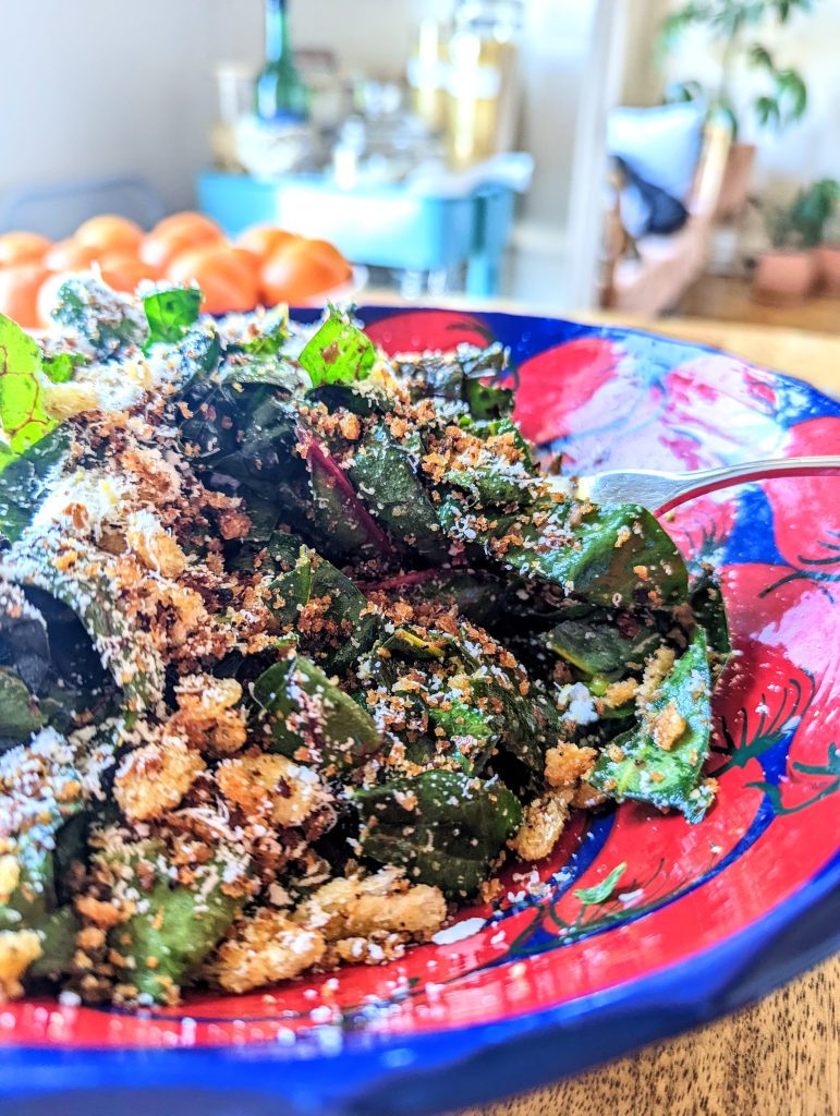 A forkful of purple veined Swiss Chard; freshly toasted golden breadcrumbs; white, finely grated Pecorino.